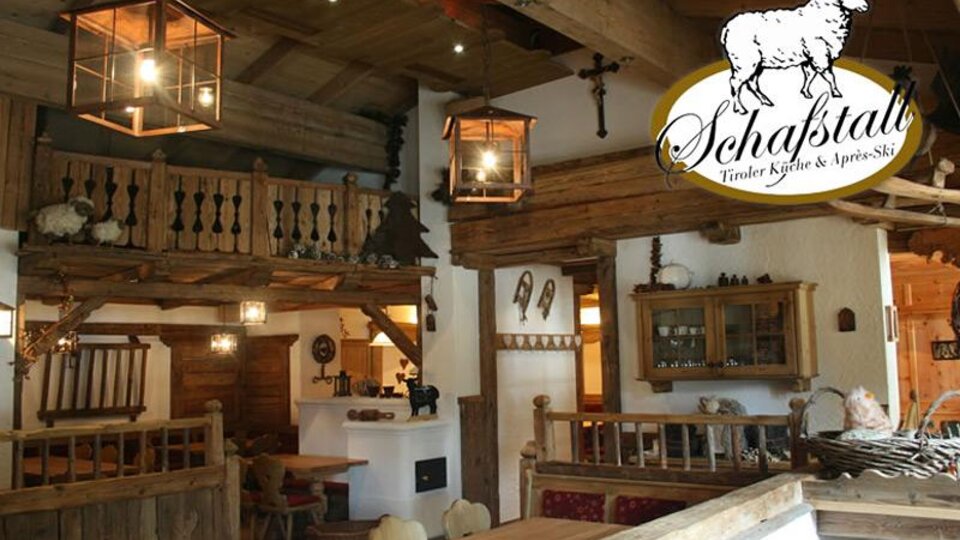 Ein gemütliches Restaurant mit rustikalem Holzinterieur und warmem Licht. Im Hintergrund sind Tische und eine gemütliche Atmosphäre zu sehen.